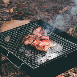 High angle view of meat on barbecue grill