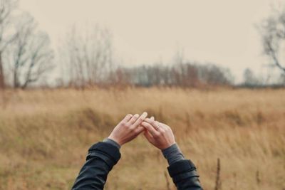 Close-up of woman hand with grass