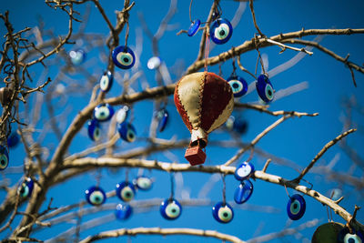 A hot balloon decorative item hanging on a tree against evil eye beads tree in pigeons valley