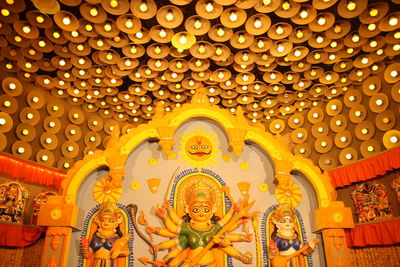 Low angle view of buddha statue in illuminated building