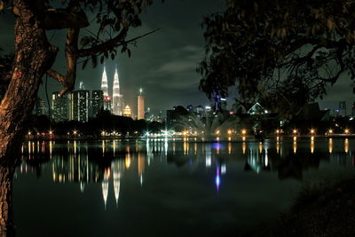 Reflection of illuminated cityscape in water at night