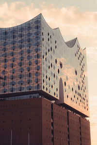 Low angle view of building against cloudy sky