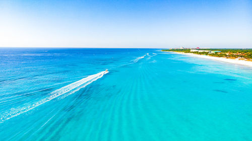 Scenic view of sea against clear blue sky