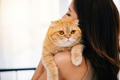 Close-up of woman with cat