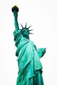 Low angle view of statue against clear blue sky