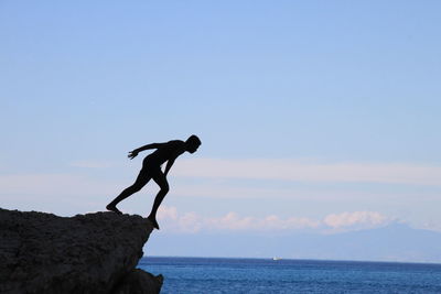 Low angle view of sea against clear blue sky