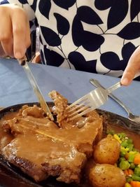 Close-up of hand holding ice cream in plate