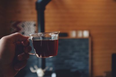 Close-up of hand holding coffee cup