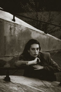 Portrait of a young woman sitting on table