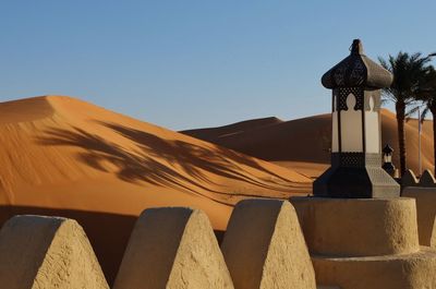 Low angle view of sand dune against clear sky