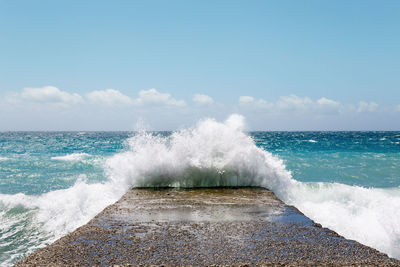 Waves breaking against sea