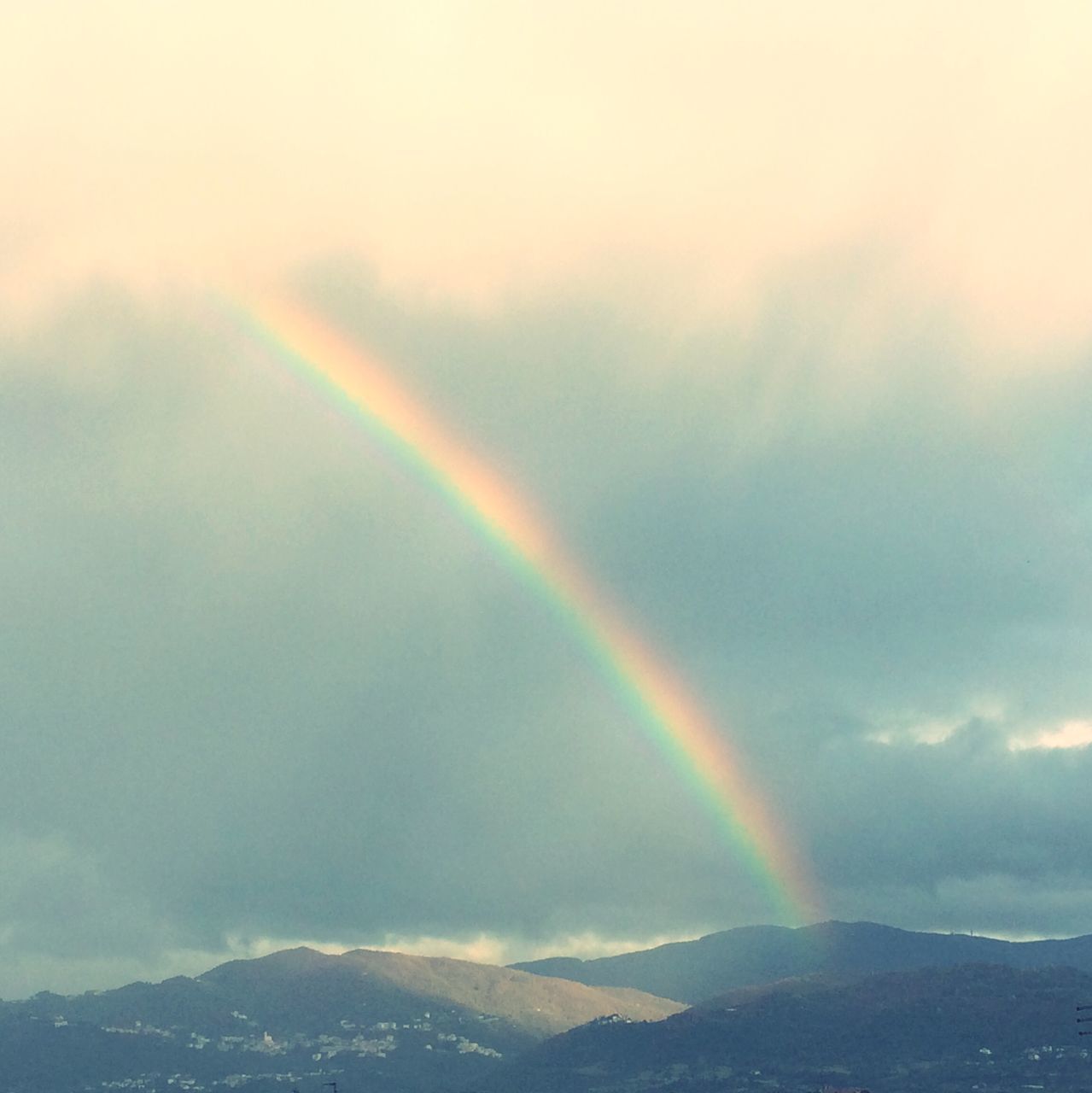 rainbow, sky, scenics, multi colored, beauty in nature, cloud - sky, tranquil scene, tranquility, nature, low angle view, idyllic, weather, cloudy, overcast, landscape, sunbeam, cloud, majestic, outdoors, dramatic sky