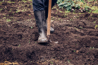 Low section of man working in mud