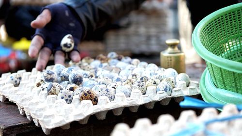 Close-up of person selling quail egg