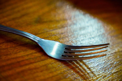 High angle view of fork on table