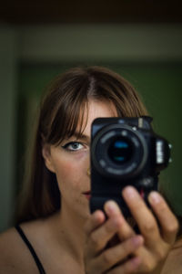 Portrait of woman photographing