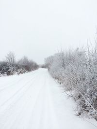 Snow covered landscape against clear sky