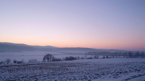 Scenic view of landscape against sky during winter