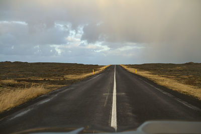 Road passing through landscape against sky