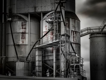 Low angle view of industry against sky