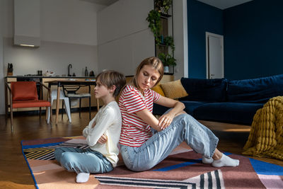 Portrait of mother and daughter at home