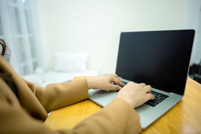 Midsection of woman using mobile phone