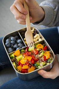 Lunchbox with quinoa salad with tomato and cucumber, blue berry and trail mix