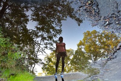 Reflection of woman on puddle