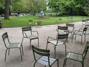 Empty chairs and table in lawn