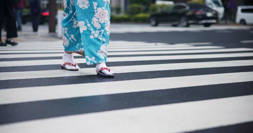 Low section of people walking on street