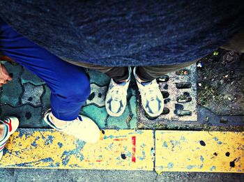 Low section of woman standing on tiled floor