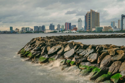 Panoramic view of sea and buildings against sky