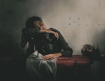 Woman sitting on sofa at home