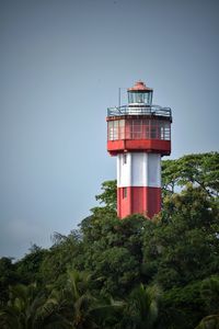 Low angle view of red lighthouse against sky