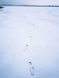 Footprints on snow covered field