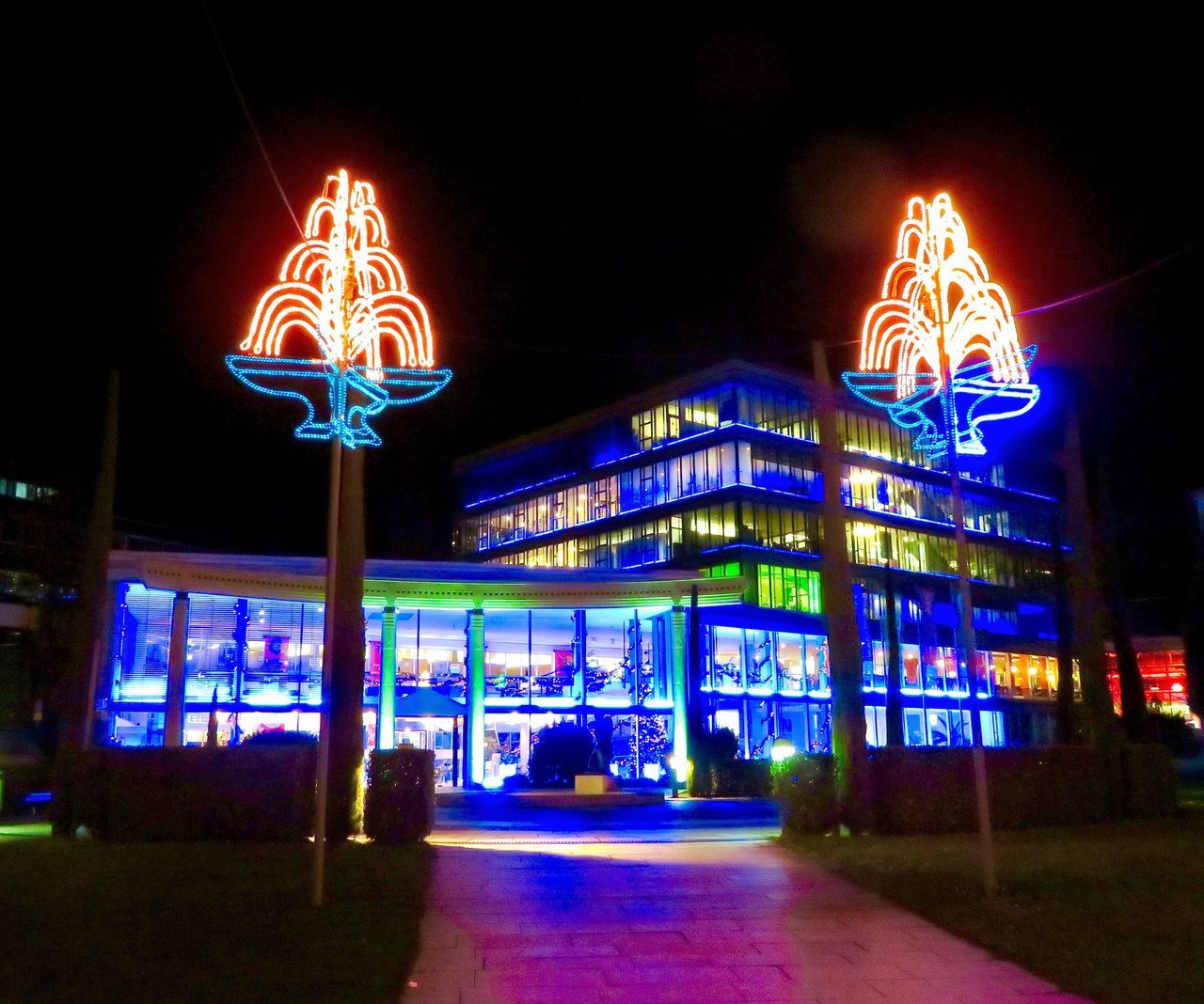 night, illuminated, architecture, built structure, building exterior, outdoors, street light, low angle view, no people, city, sky, neon