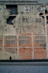 Full length of man walking against building in city