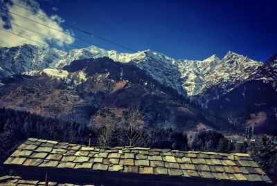 Scenic view of snowcapped mountains against blue sky