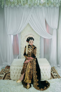Portrait of woman wearing mask at home