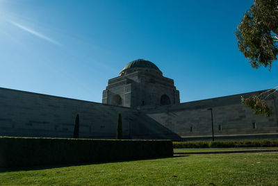 Low angle view of historical building against blue sky