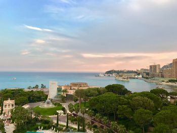 High angle view of buildings and sea against sky