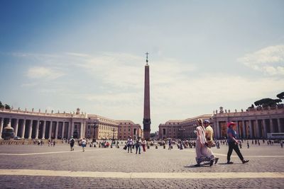 People at st peter square against sky on sunny day