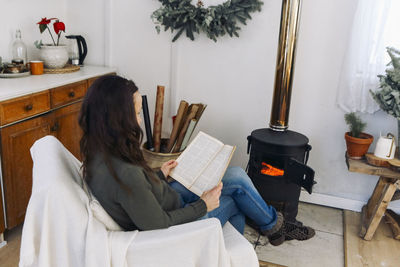 High angle view of woman sitting at home