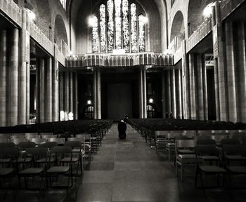 Rear view of man walking in corridor of building