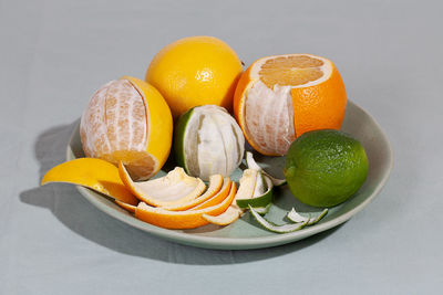 Close-up of fruits in plate against white background