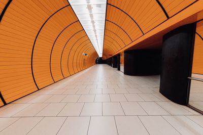 Rear view of man walking in tunnel