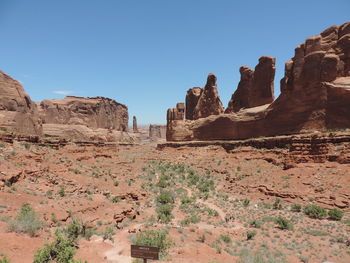 Rock formations in desert against clear blue sky