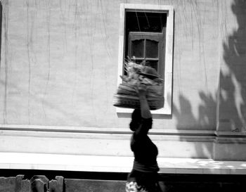 Rear view of man standing by railing