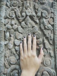 High angle view of human hand on sand