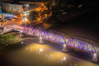 High angle view of illuminated bridge over river in city at night